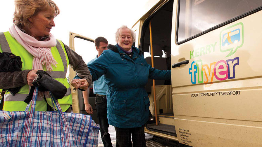 Kerry Flyer assistant helping an older lady getting off the bus